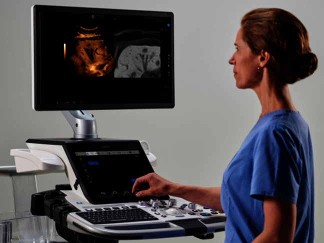 A female physician is using an ultrasound system