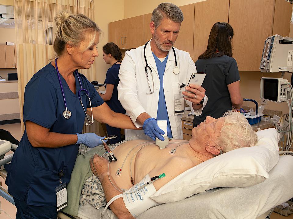 A doctor is performing an ultrasound exam at Point-of-Care with Vscan Air ultrasound system