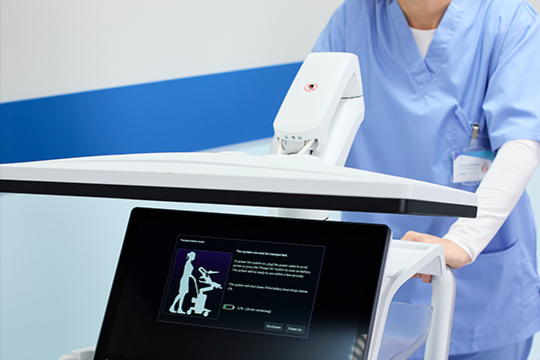 Close-up of NUVISION and AcuNav Crystal ultrasound catheters resting in the probe holders of a GE ultrasound control panel.