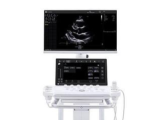 A wide banner displaying a GE ultrasound machine positioned on the right side against a solid white background, with a heart scan visible on the upper monitor.