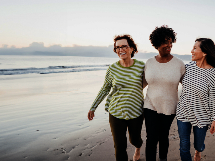 Three women walking on a beach