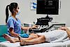 Obrázek znázorňuje lékaře provádějícího cévní ultrazvukové vyšetření u pacienta.